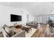 Living room with modern furniture, large TV, and breakfast bar at 4196 Eastlake Ct, Port Charlotte, FL 33948