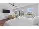 Comfortable main bedroom with ceiling fan, neutral tones, and a peaceful view of the waterfront at 4196 Eastlake Ct, Port Charlotte, FL 33948