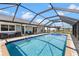 This home features a screened-in pool with spa and outdoor furniture at 4196 Eastlake Ct, Port Charlotte, FL 33948