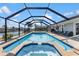 Relax in this screened-in pool with an attached jacuzzi overlooking a serene canal at 4196 Eastlake Ct, Port Charlotte, FL 33948