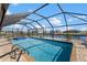 Enjoy this screened-in pool overlooking a tranquil canal with dock access at 4196 Eastlake Ct, Port Charlotte, FL 33948