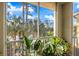 Balcony with plants overlooking scenic views of trees and lake on a bright, sunny day at 5552 Bentgrass Dr # 7-116, Sarasota, FL 34235