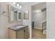 Bathroom featuring a granite vanity, updated lighting, and doorway view of wood-look stairs at 5552 Bentgrass Dr # 7-116, Sarasota, FL 34235