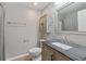Bathroom featuring granite countertop, updated vanity with dark bronze hardware and vanity mirror at 5552 Bentgrass Dr # 7-116, Sarasota, FL 34235