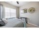 Bedroom with soft natural light, ceiling fan, and TV; a comfortable and stylish retreat at 5552 Bentgrass Dr # 7-116, Sarasota, FL 34235