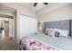 Bedroom featuring a padded gray headboard, neutral walls, and a ceiling fan at 5552 Bentgrass Dr # 7-116, Sarasota, FL 34235