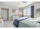 Cozy bedroom with large window, ceiling fan, light-colored walls, and carpet flooring at 5552 Bentgrass Dr # 7-116, Sarasota, FL 34235