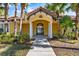 Inviting entrance to community pool area, featuring a yellow building with red tile roof at 5552 Bentgrass Dr # 7-116, Sarasota, FL 34235
