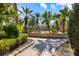 Well-manicured exterior walkway leading to a refreshing pool, perfect for relaxation and leisure at 5552 Bentgrass Dr # 7-116, Sarasota, FL 34235