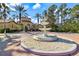 Beautiful community center with a lovely fountain, lush greenery, and palm trees at 5552 Bentgrass Dr # 7-116, Sarasota, FL 34235