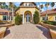 Beautiful community center with arched entrance, white columns and manicured landscaping at 5552 Bentgrass Dr # 7-116, Sarasota, FL 34235