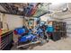 Spacious garage with overhead storage, a motorcycle, shelving and plenty of room for parking at 5552 Bentgrass Dr # 7-116, Sarasota, FL 34235