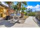 The grilling area features two stainless steel grills, a walkway, and a well-maintained landscape at 5552 Bentgrass Dr # 7-116, Sarasota, FL 34235
