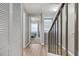 Hallway featuring light-colored flooring and neutral paint, leading to a bedroom with natural light at 5552 Bentgrass Dr # 7-116, Sarasota, FL 34235