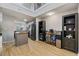 Bright kitchen features a stainless steel refrigerator, an island with a granite countertop, and wood floors at 5552 Bentgrass Dr # 7-116, Sarasota, FL 34235