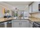 Kitchen features granite countertops, stainless steel appliances, and a view into the living area at 5552 Bentgrass Dr # 7-116, Sarasota, FL 34235