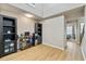 Living area with wood floors and a decorative cabinet for storage, and a hallway to the bedrooms at 5552 Bentgrass Dr # 7-116, Sarasota, FL 34235