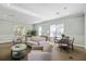 Comfortable community living room featuring couches, sitting chairs, tables, and natural light from the window at 5552 Bentgrass Dr # 7-116, Sarasota, FL 34235