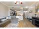 Inviting living room with a gray sectional sofa and a clear view of the open-concept kitchen at 5552 Bentgrass Dr # 7-116, Sarasota, FL 34235
