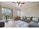 Inviting living room with sliding glass doors to the balcony, plush seating, and wood-style floors at 5552 Bentgrass Dr # 7-116, Sarasota, FL 34235
