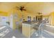 Outdoor kitchen with sink, ceiling fan, and several seating options at 5552 Bentgrass Dr # 7-116, Sarasota, FL 34235