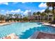 Beautiful community pool with lounge chairs, and lush tropical landscaping at 5552 Bentgrass Dr # 7-116, Sarasota, FL 34235