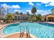 Community pool with comfortable lounge chairs, and lush landscaping at 5552 Bentgrass Dr # 7-116, Sarasota, FL 34235