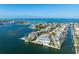 Picturesque aerial view of waterfront homes with docks, offering direct access to the bay and open waters at 624 N Point Dr, Holmes Beach, FL 34217