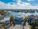 Stunning aerial view of a waterfront home showcasing its lush landscaping and desirable coastal community at 624 N Point Dr, Holmes Beach, FL 34217