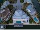 Aerial view of a home with a backyard pool and waterfront access, surrounded by lush landscaping at 624 N Point Dr, Holmes Beach, FL 34217