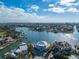 Aerial view of a luxurious waterfront property featuring lush landscaping and a serene waterfront setting at 624 N Point Dr, Holmes Beach, FL 34217