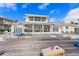 Spacious backyard with a pool, lounge chairs, and patio seating area at 624 N Point Dr, Holmes Beach, FL 34217