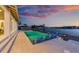 Waterfront pool, deck, and outdoor seating is the perfect place to watch the sunset at 624 N Point Dr, Holmes Beach, FL 34217