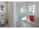 Bright bathroom featuring glass shower enclosure, window to the outside and herringbone tile floors at 624 N Point Dr, Holmes Beach, FL 34217