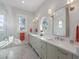 Bright bathroom featuring double vanity, herringbone floors, a porthole window, and a glass-enclosed shower at 624 N Point Dr, Holmes Beach, FL 34217