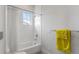 Bright bathroom with white subway tile shower, chrome fixtures, and a yellow towel on the rack at 624 N Point Dr, Holmes Beach, FL 34217
