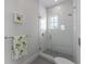 Bathroom with glass shower, white subway tiles, and decorative towel at 624 N Point Dr, Holmes Beach, FL 34217