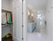 Modern bathroom with double vanity, glass enclosed shower, and walk-in closet at 624 N Point Dr, Holmes Beach, FL 34217