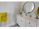 Elegant bathroom vanity featuring a round mirror, sleek faucet, and bright lighting at 624 N Point Dr, Holmes Beach, FL 34217