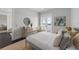 Well-lit bedroom featuring a gray bed frame, stylish decor, and access to a private balcony at 624 N Point Dr, Holmes Beach, FL 34217
