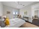 Bedroom with neutral colors, ceiling fan, and access to a small balcony at 624 N Point Dr, Holmes Beach, FL 34217