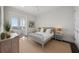 Bright bedroom featuring a gray bed frame, stylish decor, and access to a private balcony at 624 N Point Dr, Holmes Beach, FL 34217