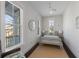 Bedroom with neutral colors, ceiling fan, and access to a small balcony at 624 N Point Dr, Holmes Beach, FL 34217