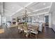 Dining area with a view of the kitchen, living room, and a fireplace, creating an open and inviting atmosphere at 624 N Point Dr, Holmes Beach, FL 34217
