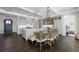 Dining area adjacent to kitchen featuring a large table, chandelier, and coffered ceilings at 624 N Point Dr, Holmes Beach, FL 34217