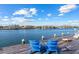 Scenic waterfront view with a charming dock featuring Adirondack chairs at 624 N Point Dr, Holmes Beach, FL 34217