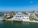 Stunning view of the rear of a waterfront home showcasing a pool, patio and dock at 624 N Point Dr, Holmes Beach, FL 34217