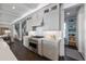 Well-equipped kitchen with stainless steel appliances, custom cabinetry, and stairs leading to the second floor at 624 N Point Dr, Holmes Beach, FL 34217