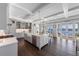 Open kitchen with a large island, modern appliances, custom cabinets, coffered ceilings, and water views at 624 N Point Dr, Holmes Beach, FL 34217
