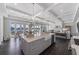Spacious kitchen with a large island, farmhouse sink, modern lighting, and doors to a patio with a view at 624 N Point Dr, Holmes Beach, FL 34217